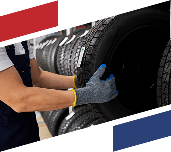 Mechanic holding a car tire - Tire Service and Replacement - Holmes Transmission and Auto Repair